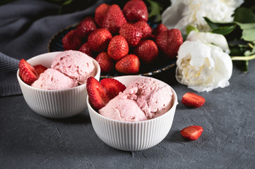 Strawberry ice cream in white bowl with fresh berries
