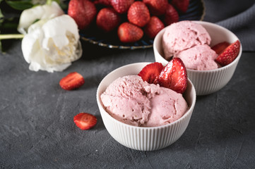 Strawberry ice cream in white bowl with fresh berries