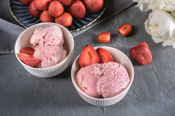 Strawberry ice cream in white bowl with fresh berries