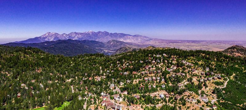 Panoramic, drone view of the San Gabriel Mountains, California leading into the high desert seen from Lake Arrowhead on a clear summer dy