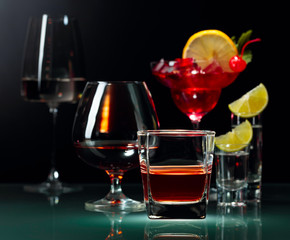 Various alcoholic drinks on a black background.