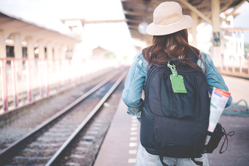 Fototapeta premium Asian tourist wait train at train station,thailand hipster womanman go to travel,Have a camera in hand