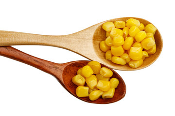 Corn seeds in a wooden spoon isolated on white background
