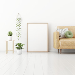 Poster mockup with vertical frame  standing on floor in living room interior with tan brown leather sofa, green pillow and plants in pots on empty white wall background. 3D rendering, illustration.