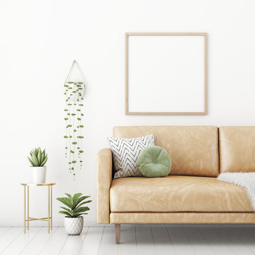 Poster mockup with square frame on empty white wall in living room interior with tan brown leather sofa, round pillow and plants in pots. 3D rendering, illustration.