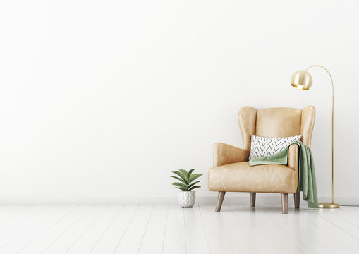 Living room interior wall mockup with tan brown leather armchair, pillow, plaid , green plant in pot and brass floor lamp on empty white wall background. 3D rendering, illustration.