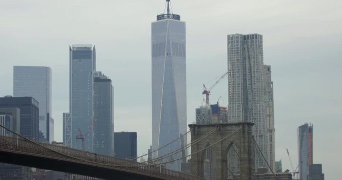 Slow Motion Shot of The Historical Brooklyn Bridge And the Impressive Famous World Trade Centre With Busy Cars Travelling on the Bridge in the Beautiful New York