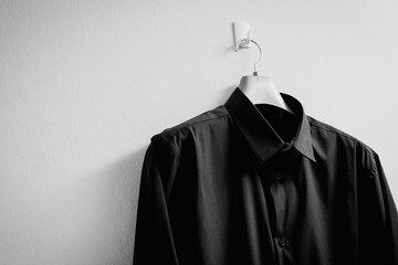 Black shirt with hanger on white background