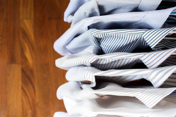Men shirts hanging on rack in a row, Top view