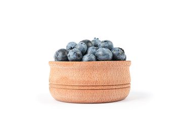 Wooden bowl with blueberries isolated on white background