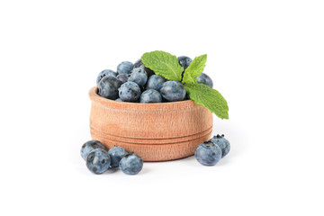 Wooden bowl with blueberries isolated on white background
