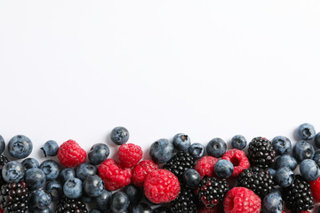 Flat lay composition with berries on white background, space for text
