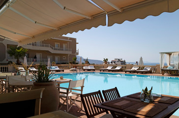 Crete, Greece. June 2019. Eating and sunbathing area around a hotel swimming pool in Crete, Greece.