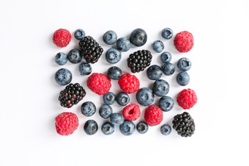 Flat lay composition with berries on white background, space for text