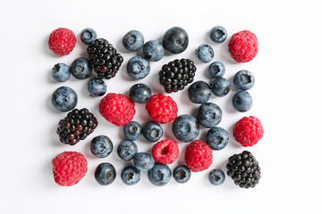 Flat lay composition with berries on white background, space for text
