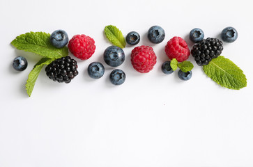 Flat lay composition with berries on white background, space for text