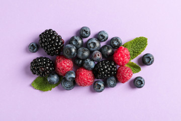 Flat lay composition with berries on color background, space for text
