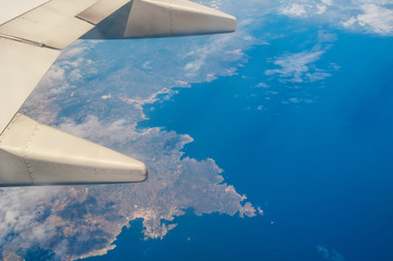 Aerial view from plane on coastline and blue sea