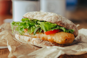 fried fish Sandwich with lettuce, tomato with tartar sauce. author's recipe street food