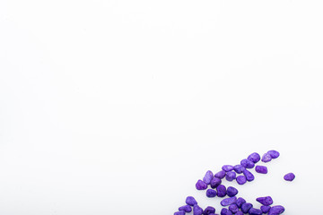 Purple pebbles stone with empty copyspace area for slogan or advertising text message, over isolated white background.