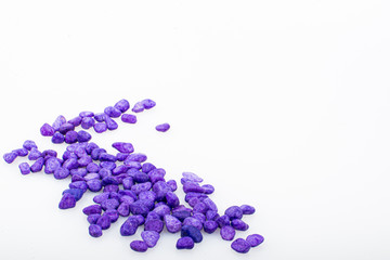 Purple pebbles stone with empty copyspace area for slogan or advertising text message, over isolated white background.