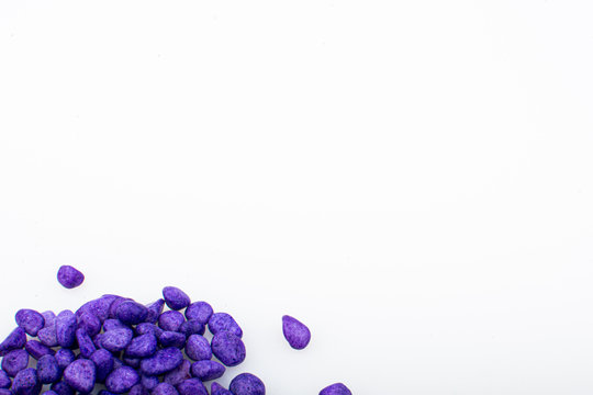 Purple pebbles stone with empty copyspace area for slogan or advertising text message, over isolated white background.