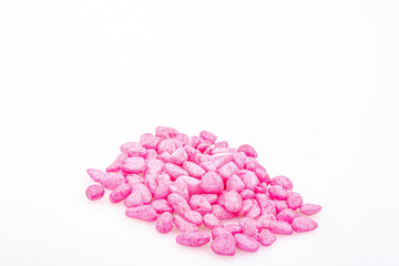 Pink pebbles stone with empty copyspace area for slogan or advertising text message, over isolated white background.