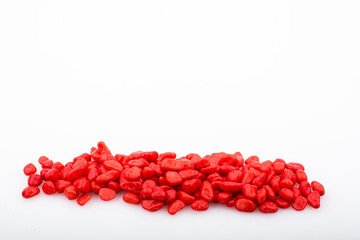 Red pebbles stone with empty copyspace area for slogan or advertising text message, over isolated white background.