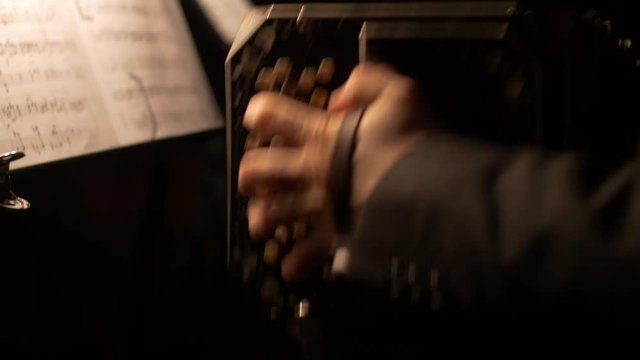 Close-up of a Bandoneon accordion, being played practicing for a tango music show.