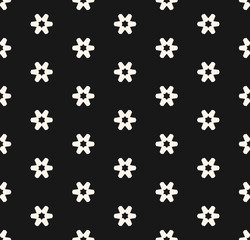 Simple monochrome seamless pattern with small geometric flowers, snowflakes