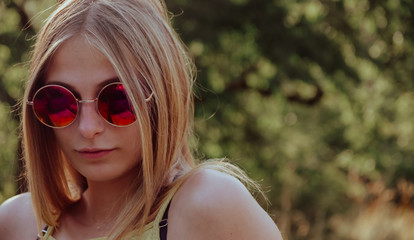 Attractive blond woman in trendy red sunglasses