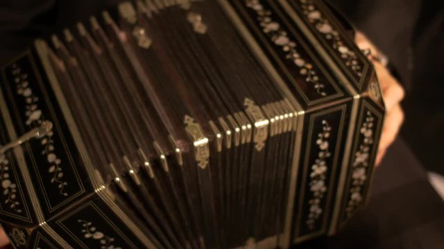 Handheld shot of a Bandoneon accordion, being played for a tango music show.