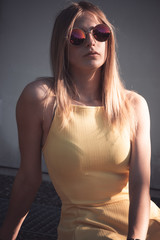 Attractive blond woman in trendy red sunglasses
