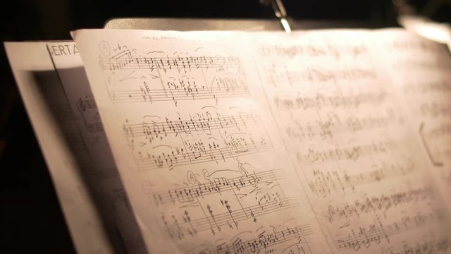 Camera moving over a music sheet showing notes of a tango instrumental piece.