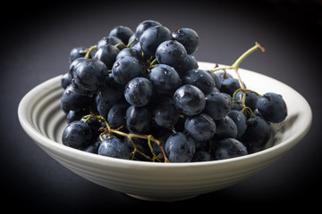 Dark grape in bowl.