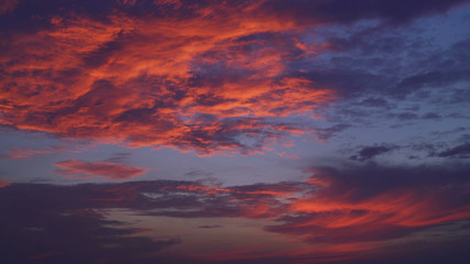 evening sky with thunderclouds. Natural view with blue and red, magenta colors clouds.