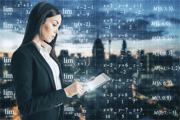 Businesswoman looking at formulas