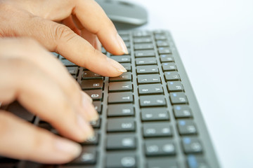 Selective focus, Woman hand working at home office on modern keyboard.