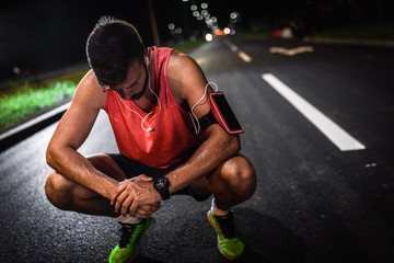 Man resting after night workout in the city.