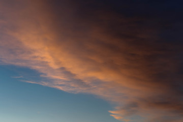 Fototapeta na wymiar dark blue clouds on pink from sunset sky