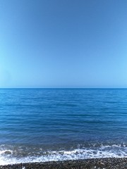 Fototapeta premium seascape in blue tones, the horizon line is located in the center of the image, there is free space for text, copy space, vertical