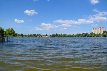 View of the lake and green forest. Fabulous landscape in summer.