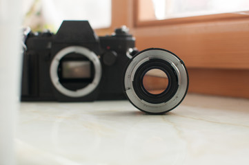 Old black film camera with lens