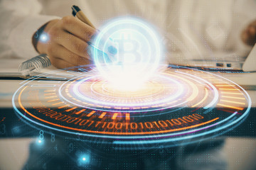 Cryptocurrency hologram over woman's hands writing background. Concept of blockchain. Double exposure