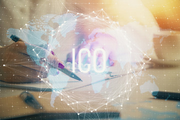Cryptocurrency hologram over woman's hands writing background. Concept of blockchain. Double...