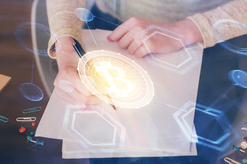 Cryptocurrency hologram over woman's hands writing background. Concept of blockchain. Multi exposure