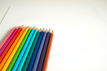 Photo of many color pencils on white background. Various colors. Advertising, blog post, newsletters.