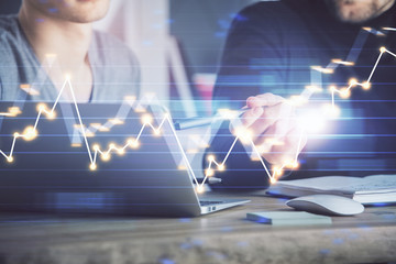 Forex graph with businessman typing on computer in office on background. Concept of analysis. Double exposure.