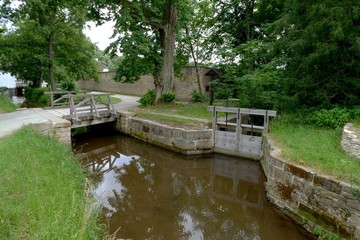 Fototapeta na wymiar wooden water-gate and bridge over creek