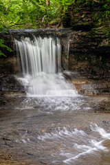 Fototapeta premium The Cascades at Glen Helen - The Cascades waterfall, on Birch Creek, splashes into a rocky ravine along the Innman Trail at Glen Helen Nature Preserve in Yellow Springs, Ohio.